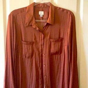 Lovely silky rust orange colored long sleeved top with collar and button up